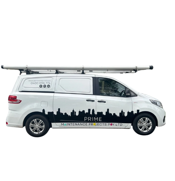 White Prime Maintenance Projects service van with roof rack, displaying company branding, Melbourne skyline graphic, and contact details on a clean exterior.